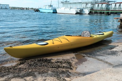 Modern kayak on beach near river. Summer camp activity