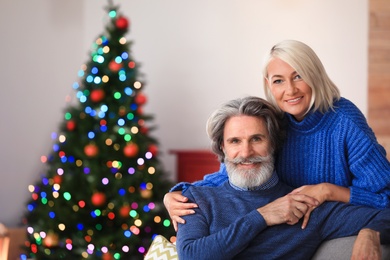 Happy mature couple celebrating Christmas at home