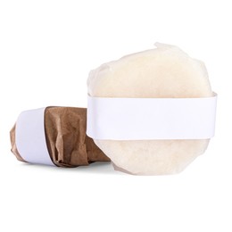 Solid shampoo bars wrapped in parchment on white background