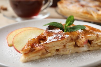 Photo of Slice of traditional apple pie on plate, closeup