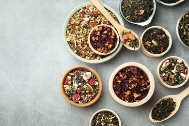 Many different herbal teas on grey table, flat lay