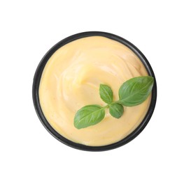 Tasty cheese sauce with basil in bowl isolated on white, top view