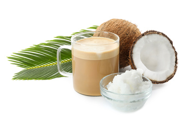 Delicious coffee with organic coconut oil and palm leaf isolated on white