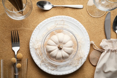 Autumn place setting with pumpkin on table, flat lay