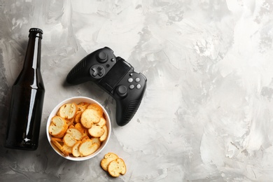 Flat lay composition with video game controller and space for text on grey background
