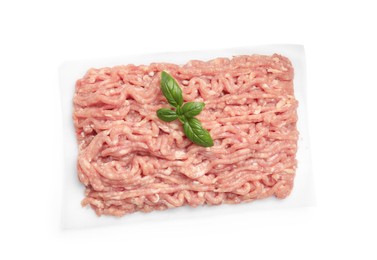 Raw chicken minced meat with basil on white background, top view