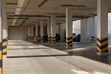 Open parking garage with cars on sunny day