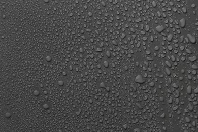 Many water drops on dark grey background