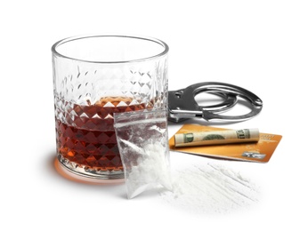 Composition with cocaine and glass of alcohol on white background