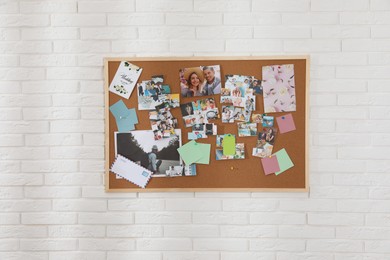Vision board with different photos representing dreams on white brick wall