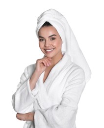 Beautiful young woman wearing bathrobe and towel on head against white background