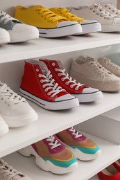 White shelving unit with collection of colorful sneakers