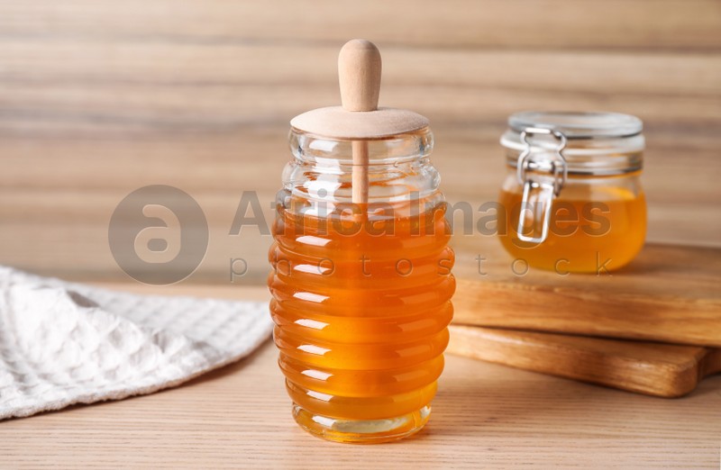 Photo of Tasty fresh organic honey on wooden table