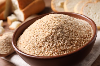Fresh bread crumbs in bowl on table, closeup
