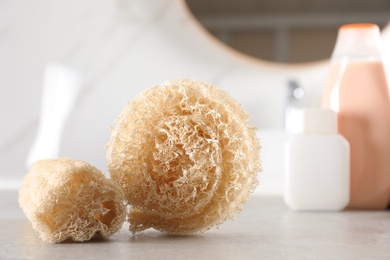 Natural loofah sponges on table in bathroom
