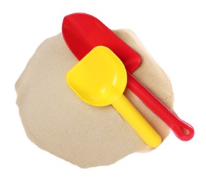 Plastic toy shovels and pile of sand on white background, top view