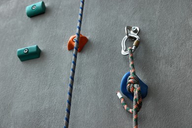 Colorful climbing wall with holds and ropes. Extreme sport
