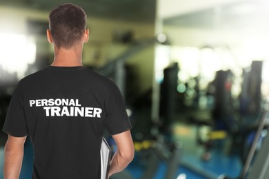 Image of Professional personal trainer with clipboard in gym. Space for text