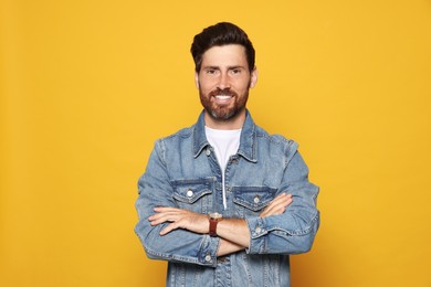 Photo of Portrait of smiling bearded man on orange background