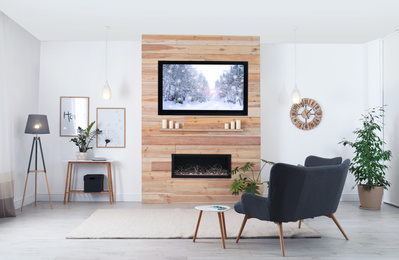 Image of Living room interior with decorative fireplace and modern TV set