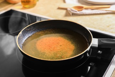 Frying pan with used cooking oil on stove