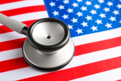 Stethoscope on American flag, closeup. USA medicine and health care concept