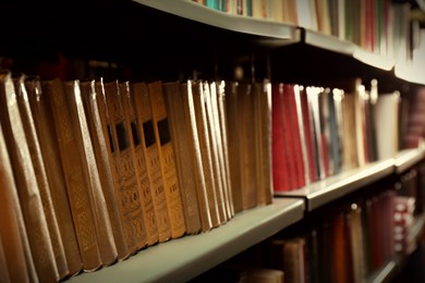 Collection of different books on shelf in library