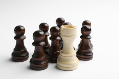White rook with black pawns on light background. Career promotion concept