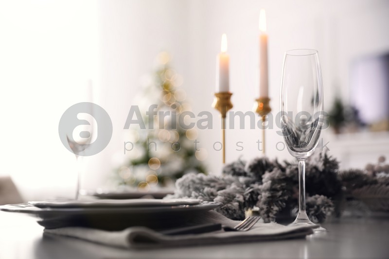Table with festive setting and candles at home