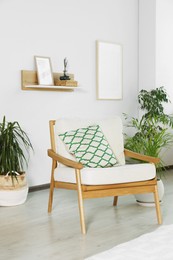 Stylish room interior with comfortable armchair and beautiful houseplants