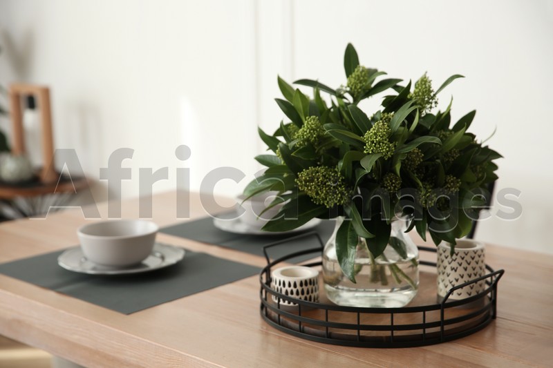 Fresh bouquet on dining table in room, closeup. Interior design