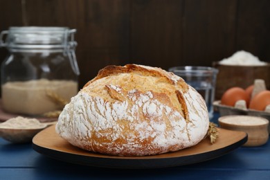 Photo of Freshly baked bread on blue wooden table