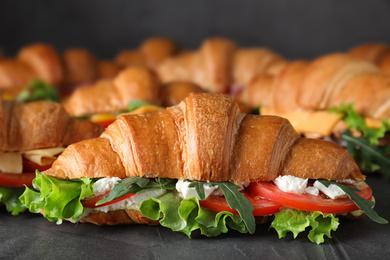 Tasty croissant sandwiches on grey table, closeup