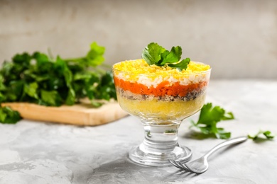 Photo of Traditional russian salad Mimosa served on light grey table
