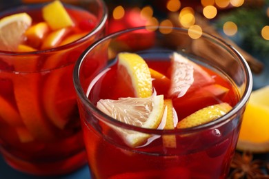 Glass with delicious punch drink on table, closeup