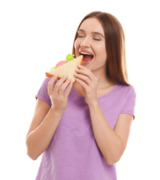 Photo of Young woman eating tasty sandwich on white background
