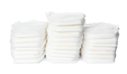 Stacks of baby diapers isolated on white