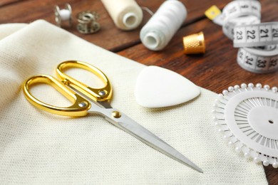 Threads and other sewing supplies on wooden table