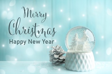 Merry Christmas and Happy New Year. Beautiful snow globe and fir cone on light blue background, bokeh effect