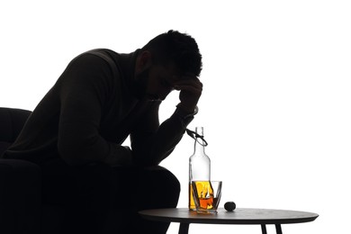 Silhouette of addicted man in handcuffs with alcohol bottle on white background