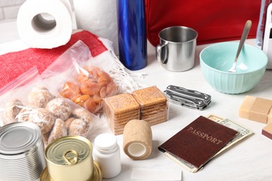 Photo of Disaster supply kit for earthquake on white wooden table