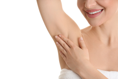 Young beautiful woman showing armpit with smooth clean skin on white background, closeup