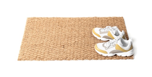 New clean doormat with shoes on white background