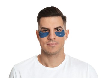 Man with blue under eye patches on white background