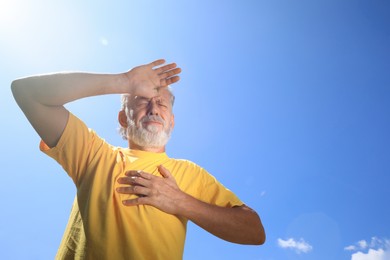 Senior man suffering from heat stroke outdoors