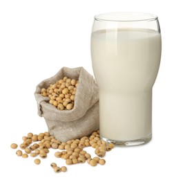 Glass of fresh soy milk and sack bag with beans on white background