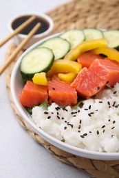 Photo of Delicious poke bowl with salmon, rice and vegetables on white table, closeup