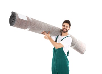 Young worker carrying rolled carpet isolated on white. Moving service