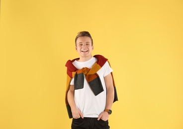 Portrait of stylish teenage boy on color background