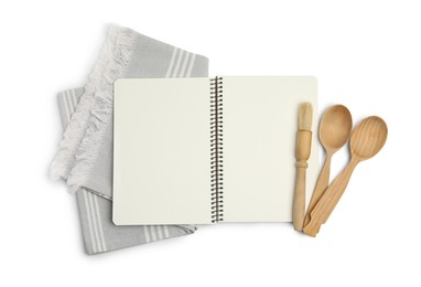 Blank recipe book, napkin and wooden utensils on white background, top view. Space for text